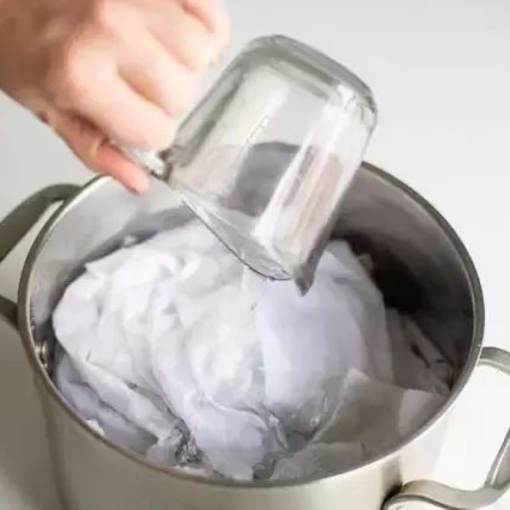 If you are hand washing, then bring the water to a boil, add white vinegar, soak the garment completely in the water, wash normally overnight and the stains are gone.